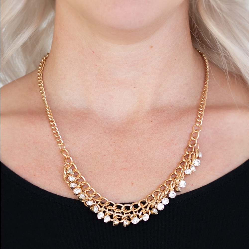 Golden and clear gem necklace with matching earrings.